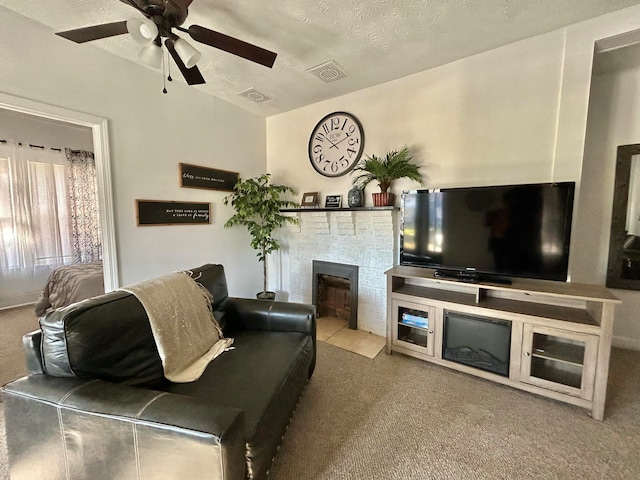 carpeted living room featuring a textured ceiling and ceiling fan