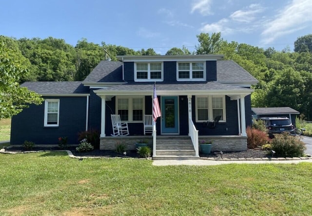 bungalow featuring a front yard and covered porch