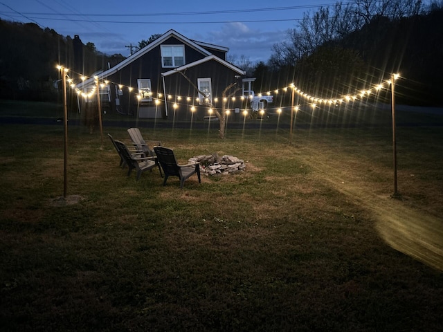 yard at dusk featuring a fire pit