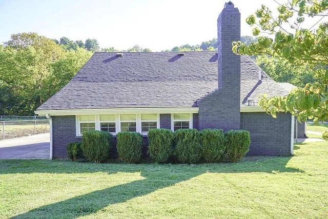 view of side of home with a yard