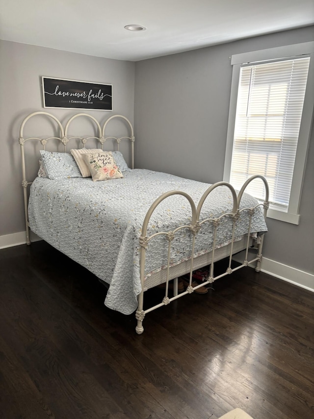 bedroom with dark wood-type flooring