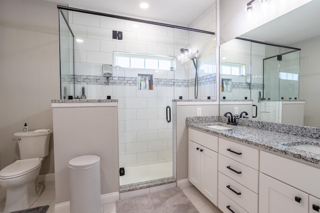 bathroom featuring a shower with door, toilet, tile patterned floors, and vanity