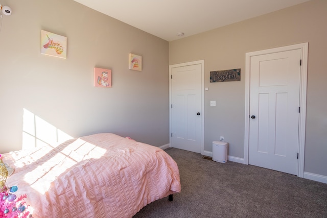 bedroom featuring dark colored carpet