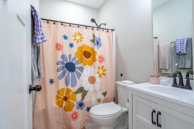 bathroom with vanity, toilet, and curtained shower