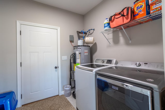 laundry room featuring water heater, light tile patterned flooring, and washer and clothes dryer