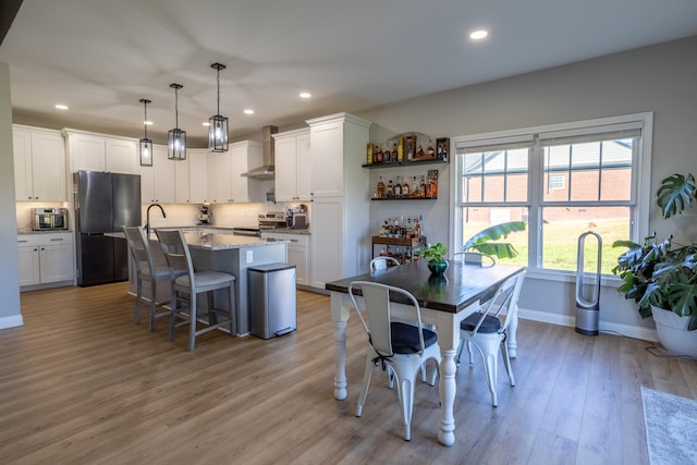 dining space with light hardwood / wood-style flooring