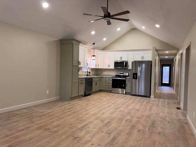 kitchen featuring appliances with stainless steel finishes, green cabinets, hanging light fixtures, sink, and light hardwood / wood-style floors