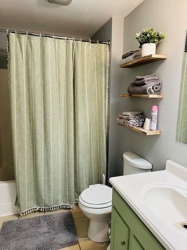 full bathroom with shower / bath combo, vanity, a textured ceiling, tile patterned flooring, and toilet