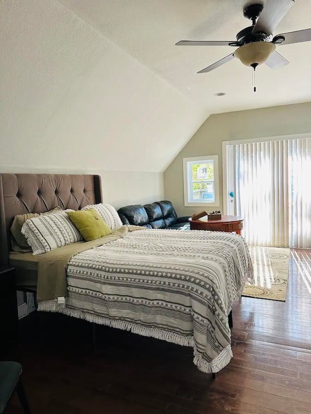 bedroom featuring ceiling fan, dark hardwood / wood-style floors, and vaulted ceiling