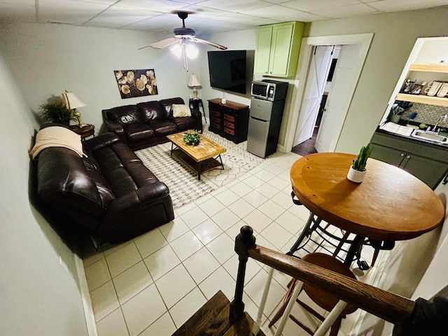 tiled living room with a paneled ceiling