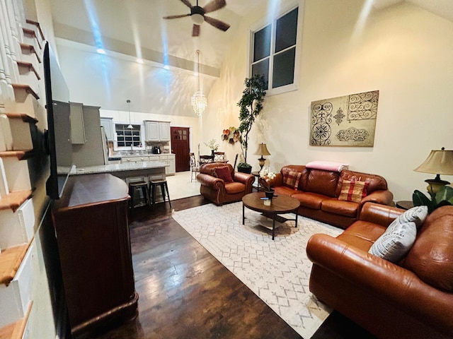 living room with ceiling fan and high vaulted ceiling