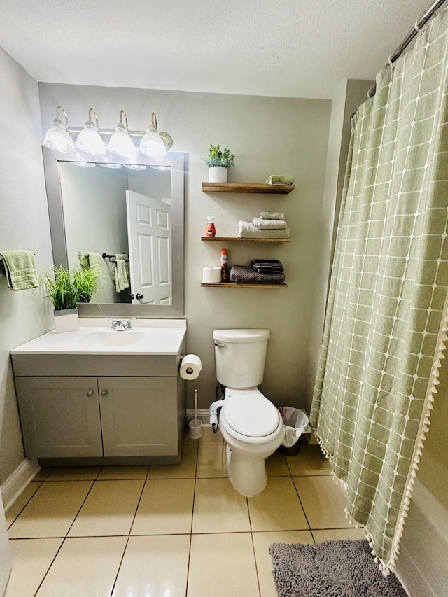 bathroom with curtained shower, tile patterned flooring, a textured ceiling, toilet, and vanity