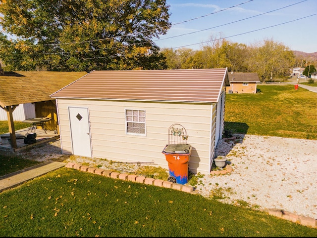 view of outbuilding with a lawn