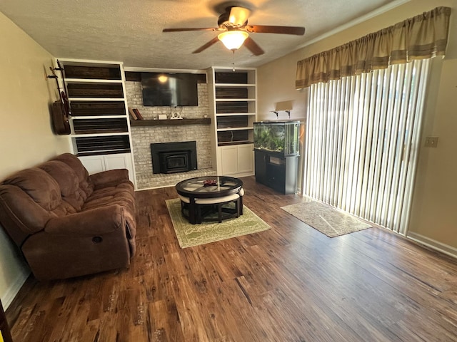 living room with ceiling fan, dark hardwood / wood-style floors, and a textured ceiling