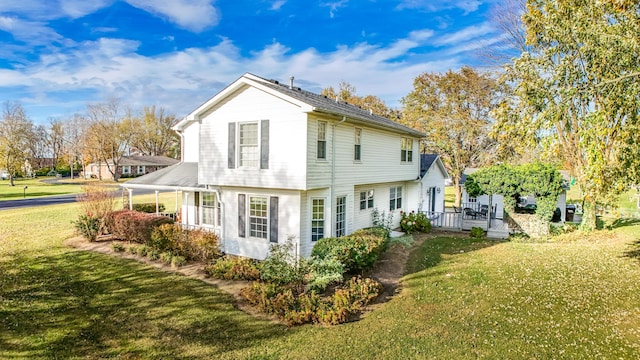 back of house featuring a yard