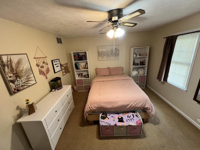 carpeted bedroom with a textured ceiling and ceiling fan