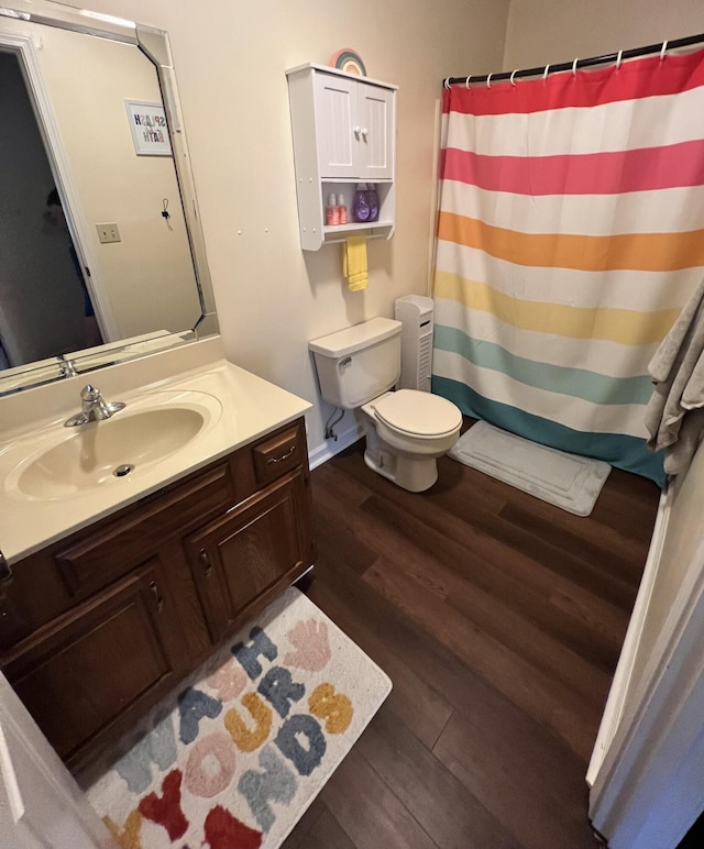 bathroom with hardwood / wood-style floors, vanity, and toilet