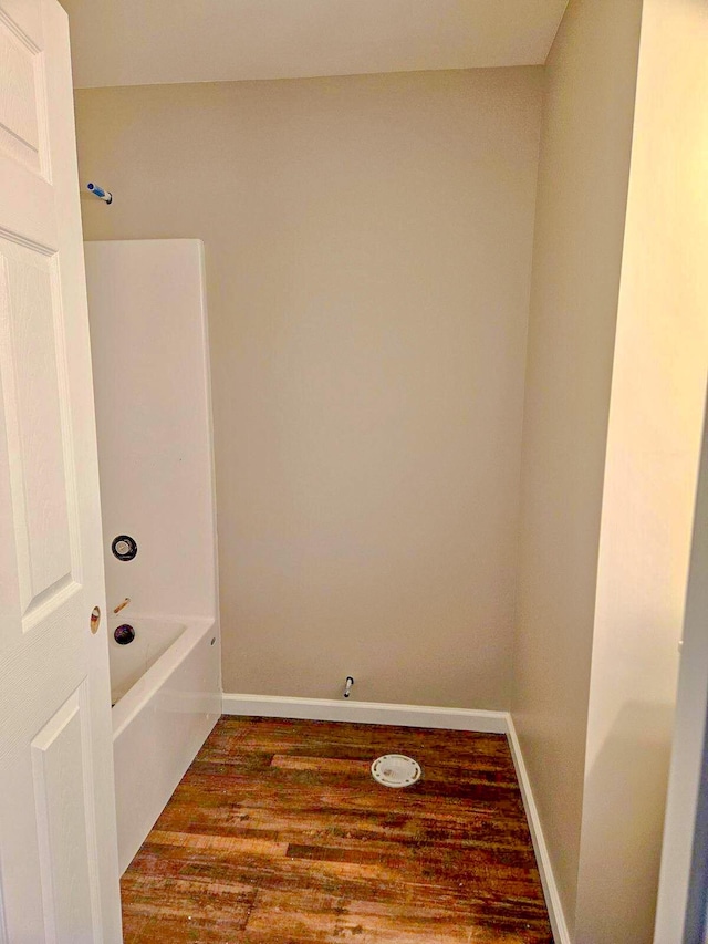 bathroom featuring hardwood / wood-style flooring and a bathing tub