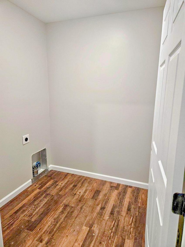 clothes washing area with wood-type flooring and electric dryer hookup