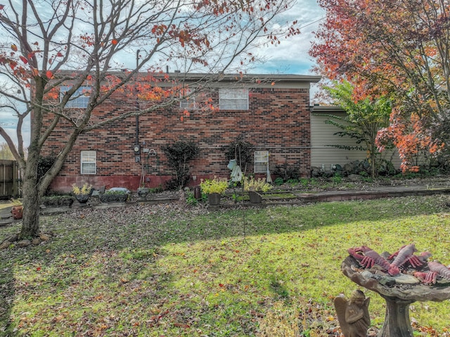 view of side of home with a lawn