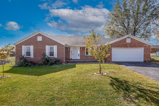 ranch-style home with a garage and a front lawn