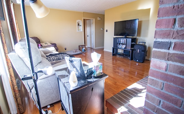 living room with hardwood / wood-style floors and a textured ceiling