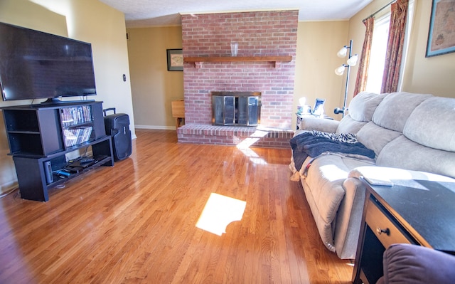 living room featuring a fireplace and light hardwood / wood-style flooring