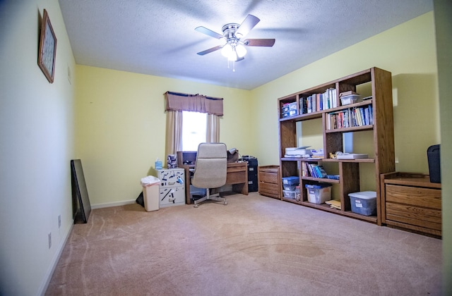 carpeted office with ceiling fan and a textured ceiling