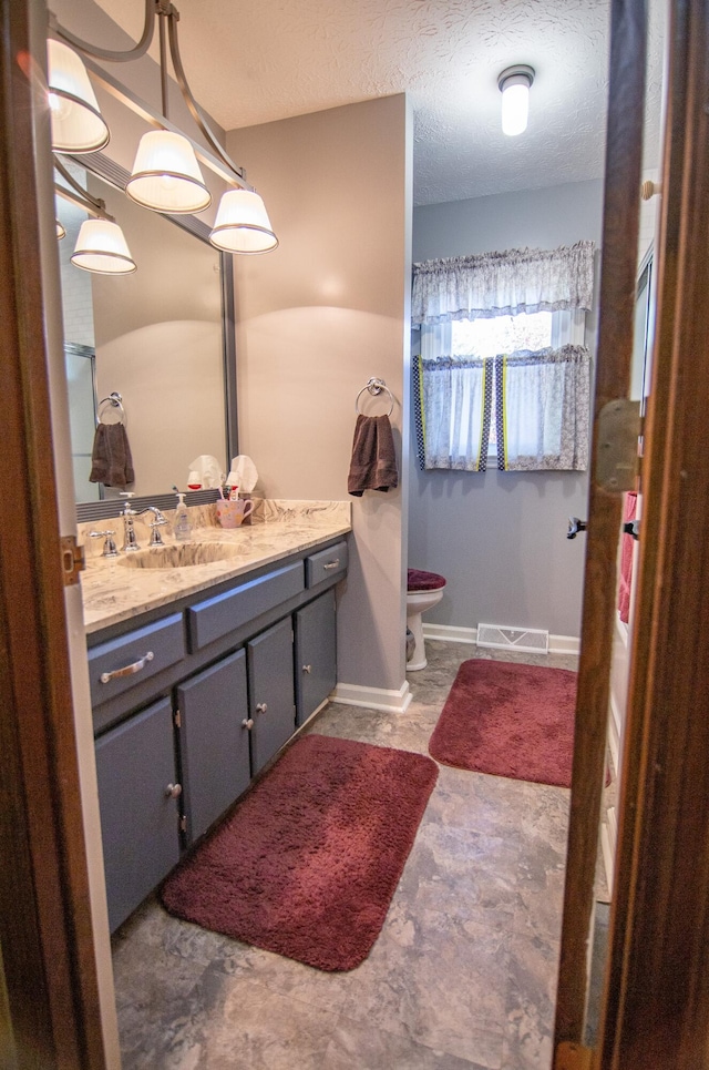 bathroom featuring vanity and a textured ceiling