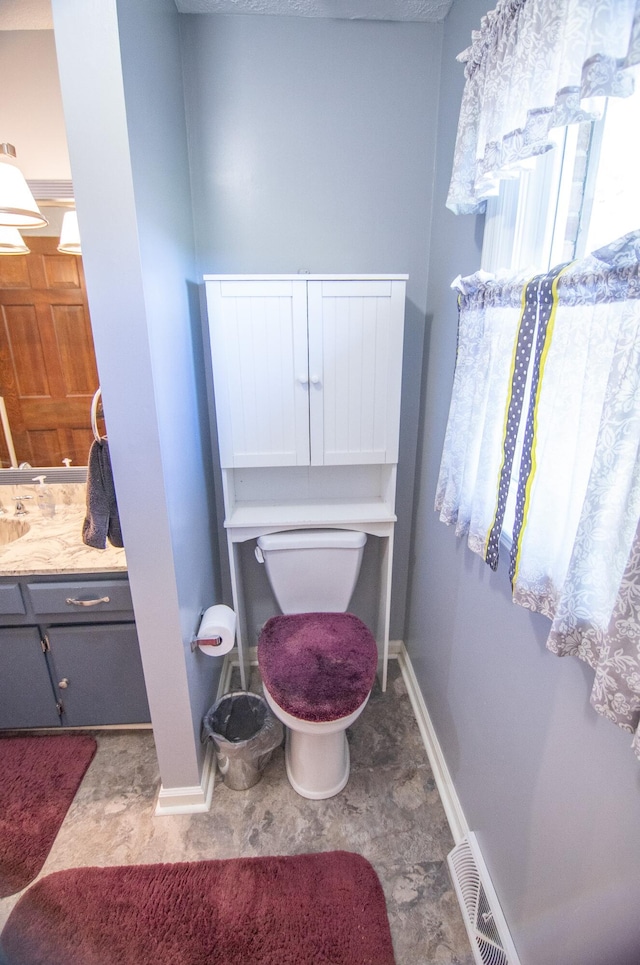 bathroom featuring vanity and toilet