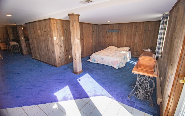 bedroom featuring wood walls and carpet floors