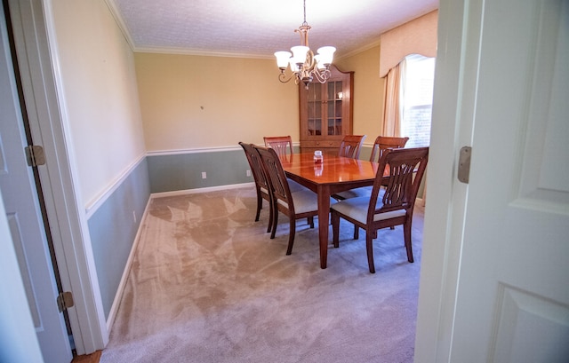 dining room featuring an inviting chandelier, light colored carpet, ornamental molding, and a textured ceiling