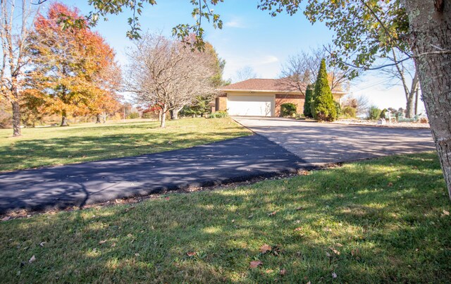 exterior space featuring a front lawn and a garage