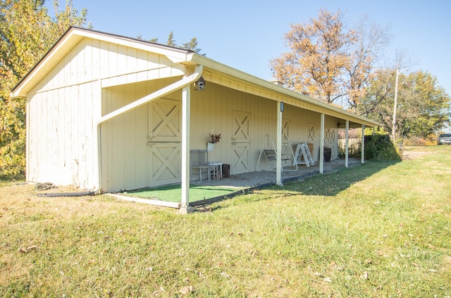 view of outbuilding featuring a lawn