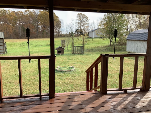 deck featuring a shed and a yard