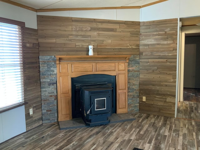 interior details featuring wooden walls, a wood stove, hardwood / wood-style flooring, and ornamental molding