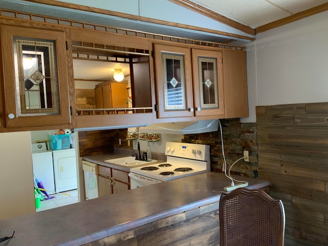 kitchen with separate washer and dryer, sink, white appliances, crown molding, and vaulted ceiling