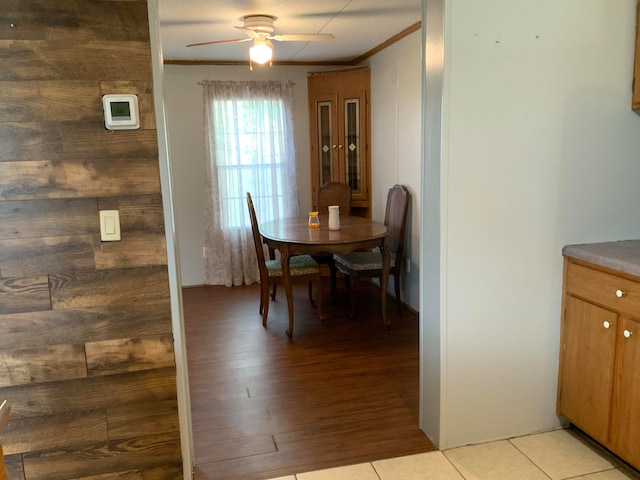 dining area featuring ceiling fan, light hardwood / wood-style flooring, and crown molding