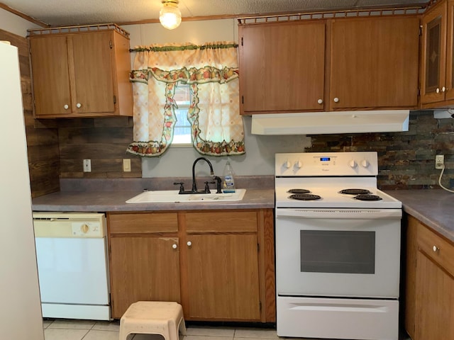 kitchen with backsplash, a textured ceiling, light tile patterned floors, sink, and white appliances