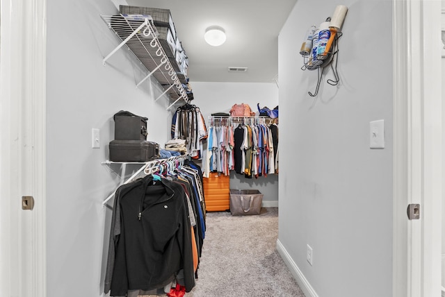 walk in closet featuring carpet