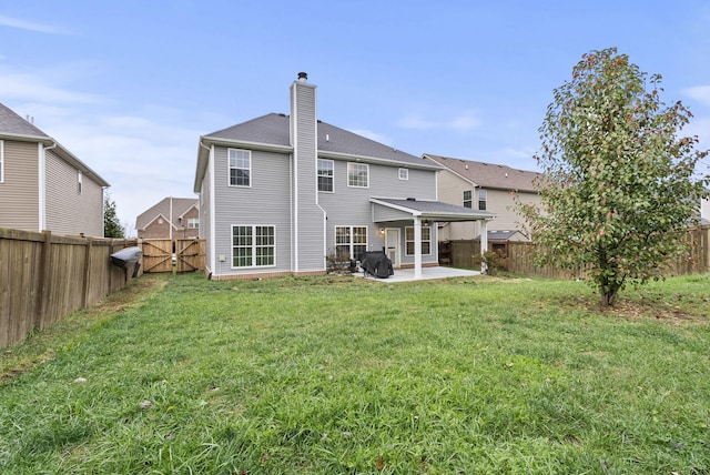 back of property with a lawn and a patio