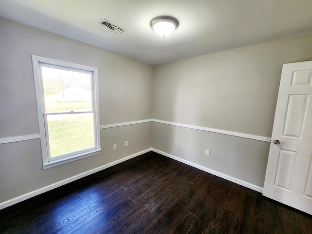 unfurnished room with dark hardwood / wood-style floors