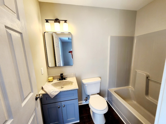 full bathroom with toilet, bathtub / shower combination, vanity, and hardwood / wood-style flooring