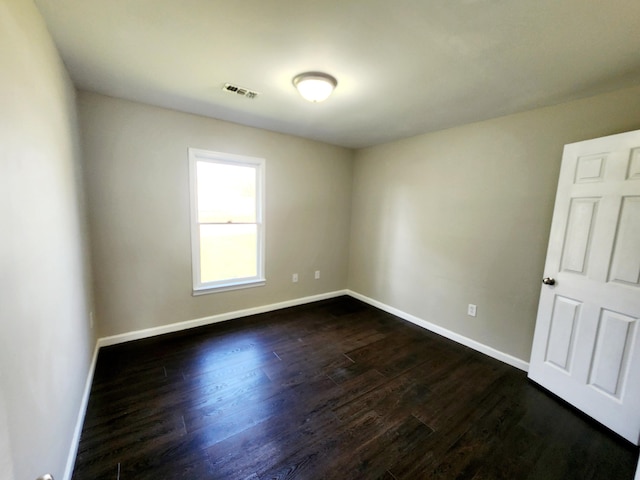 empty room with dark hardwood / wood-style floors