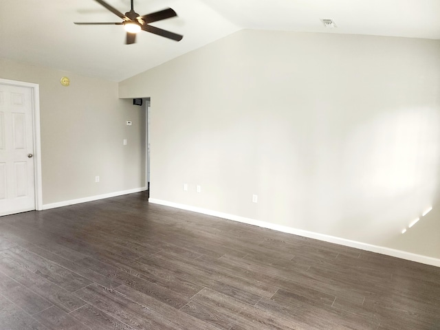 spare room featuring dark wood-type flooring, ceiling fan, and lofted ceiling