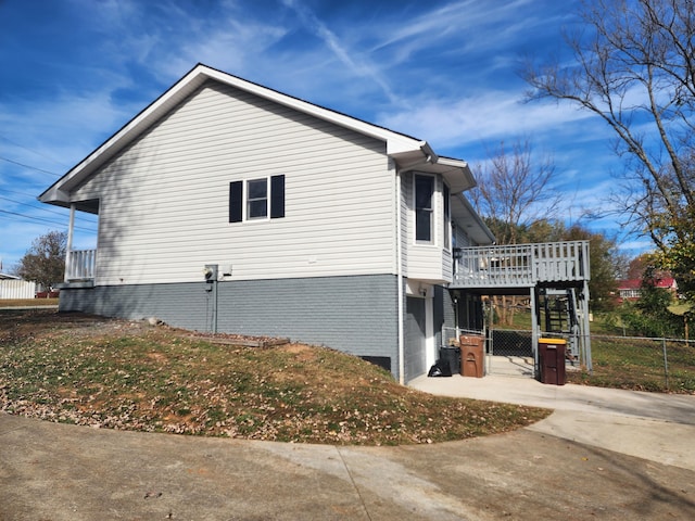 view of side of home with a deck