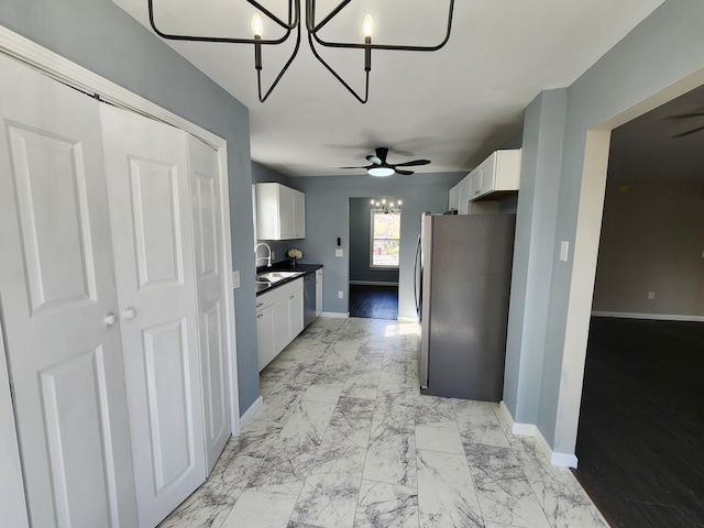 kitchen featuring white cabinetry, appliances with stainless steel finishes, sink, and ceiling fan