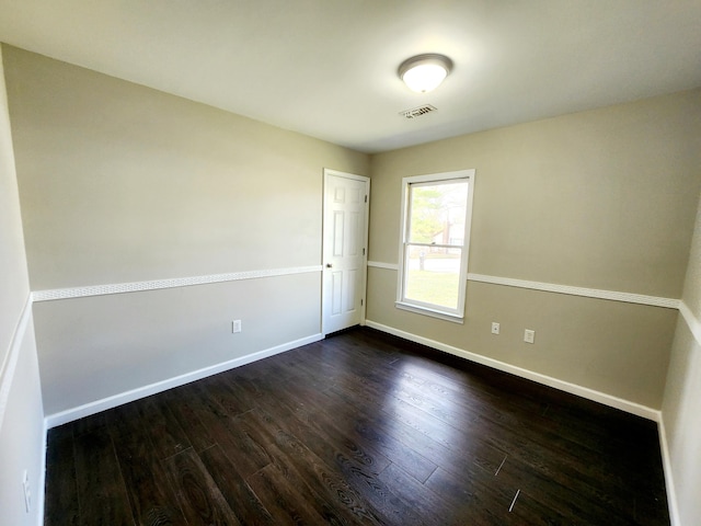 empty room with dark wood-type flooring