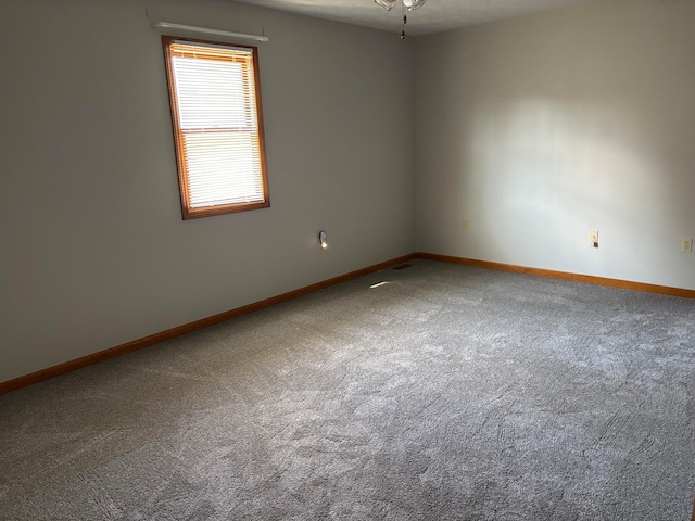 empty room with carpet floors and ceiling fan