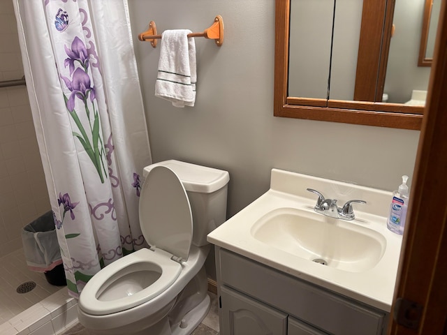 bathroom featuring curtained shower, vanity, and toilet